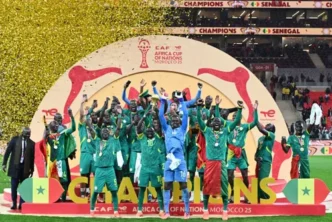 Senegal players celebrate with the trophy