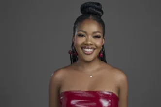 Liema Pantsi holding the Big Brother Mzansi trophy