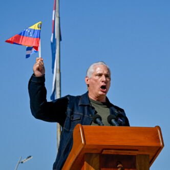 Cuban flag with oil rigs in the background