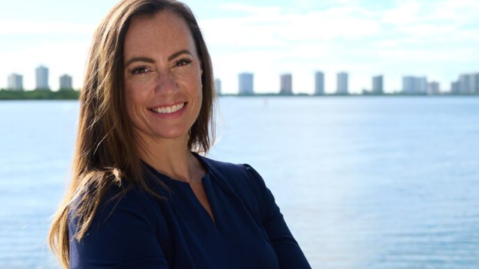 Democrat Emily Gregory smiling, with a background of the Florida statehouse