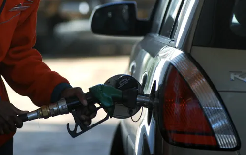 Fuel pump with a sign indicating a price increase
