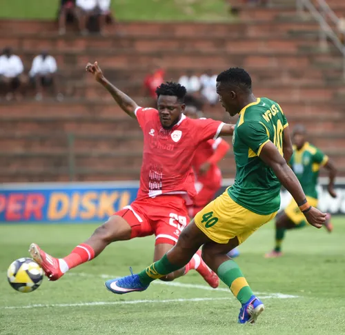 Lungelo Nguse of Lamontville Golden Arrows takes on the TS Galaxy defence