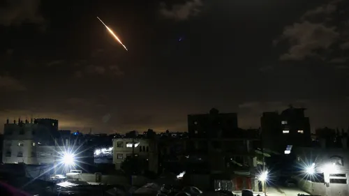 A projectile leaves behind a trail in the sky as seen from Gaza City