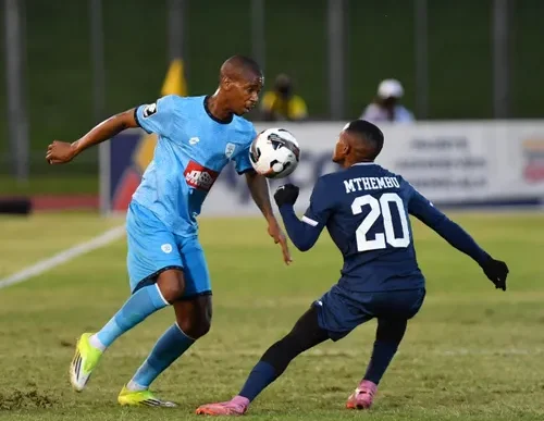 Fezile Gcaba of Durban City is challenged by Richards Bay's Moses Mthembu