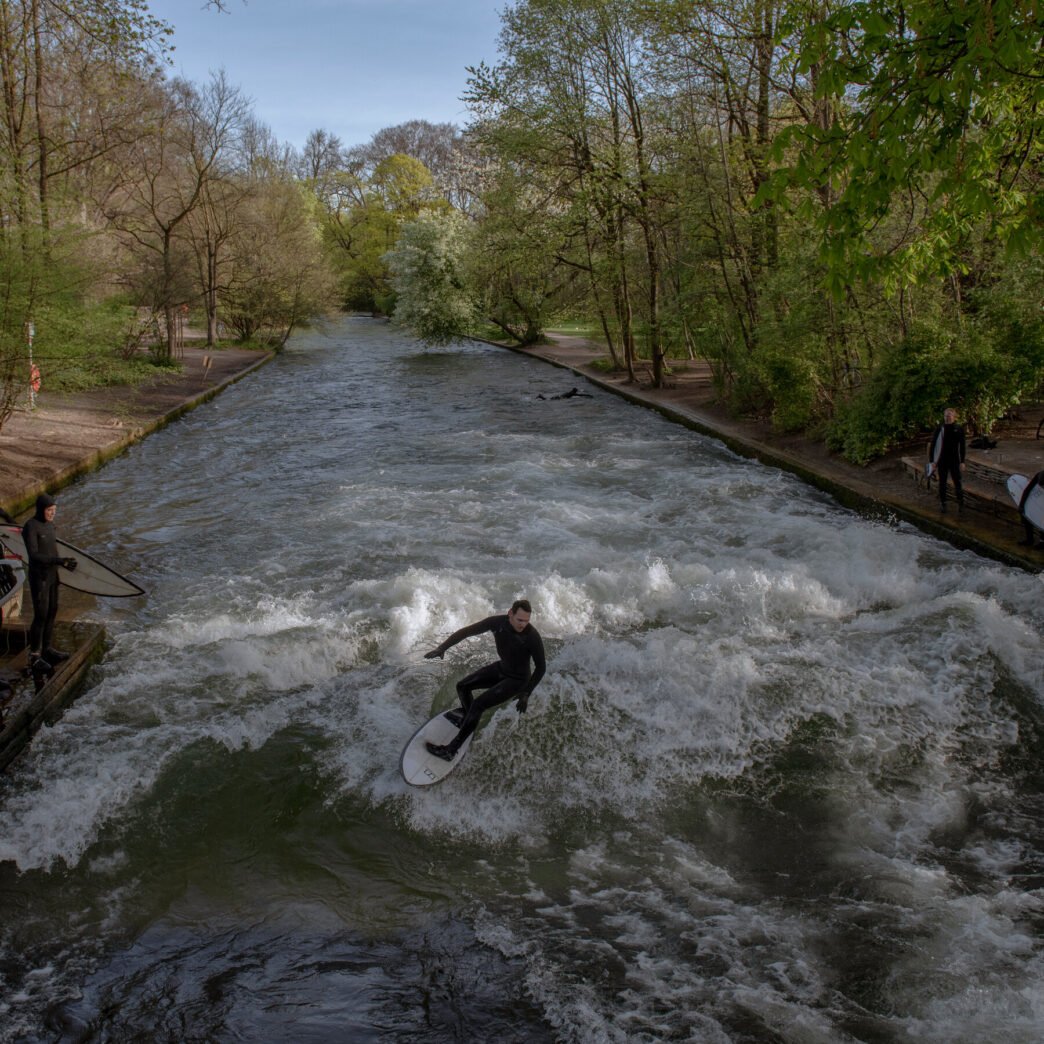 Surfers riding the wave at Eisbach creek