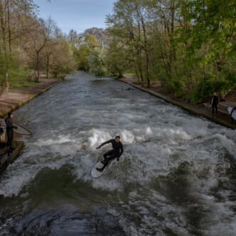 Surfers riding the wave at Eisbach creek
