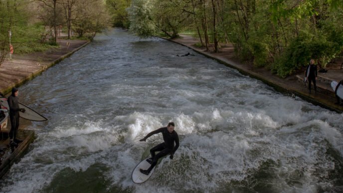 Surfers riding the wave at Eisbach creek