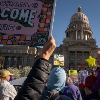 Protesters holding signs during a No Kings protest