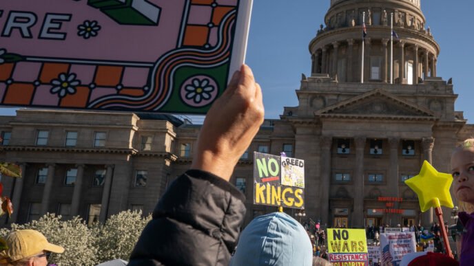 Protesters holding signs during a No Kings protest
