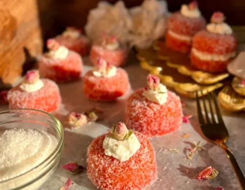 A plate of snowballs with coconut and cream