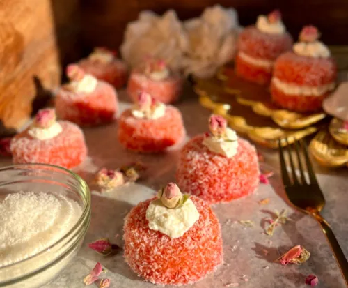 A plate of snowballs with coconut and cream
