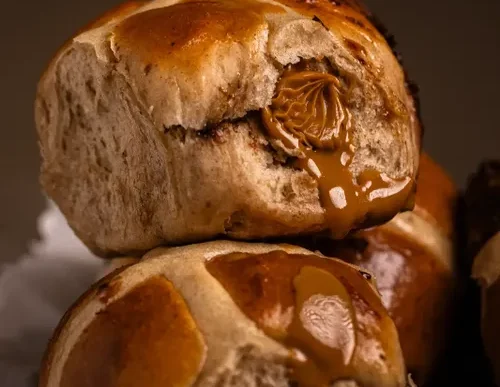 Biscoff hot cross buns on a baking tray