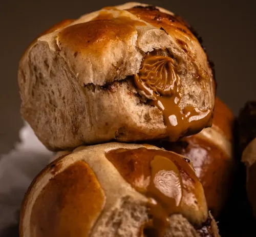 Biscoff hot cross buns on a baking tray