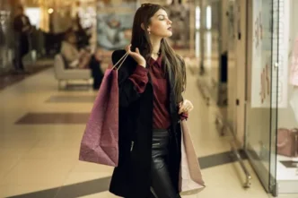A person holding a bag of clothes