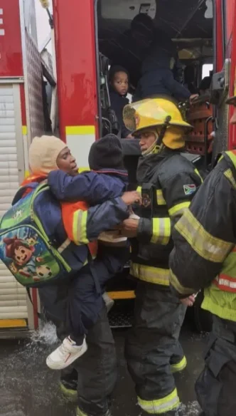 Fire truck rescuing children from flooding