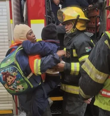 Fire truck rescuing children from flooding