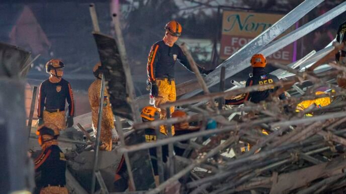 Rescue efforts underway at the site of the building collapse in the Philippines